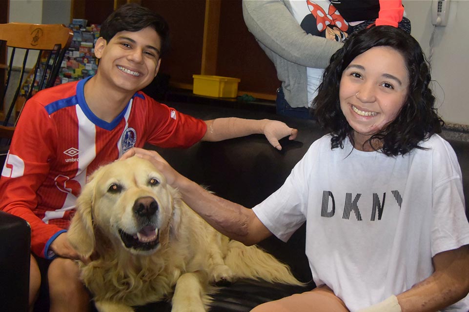 Juan Diego and female patient with pet therapy dog