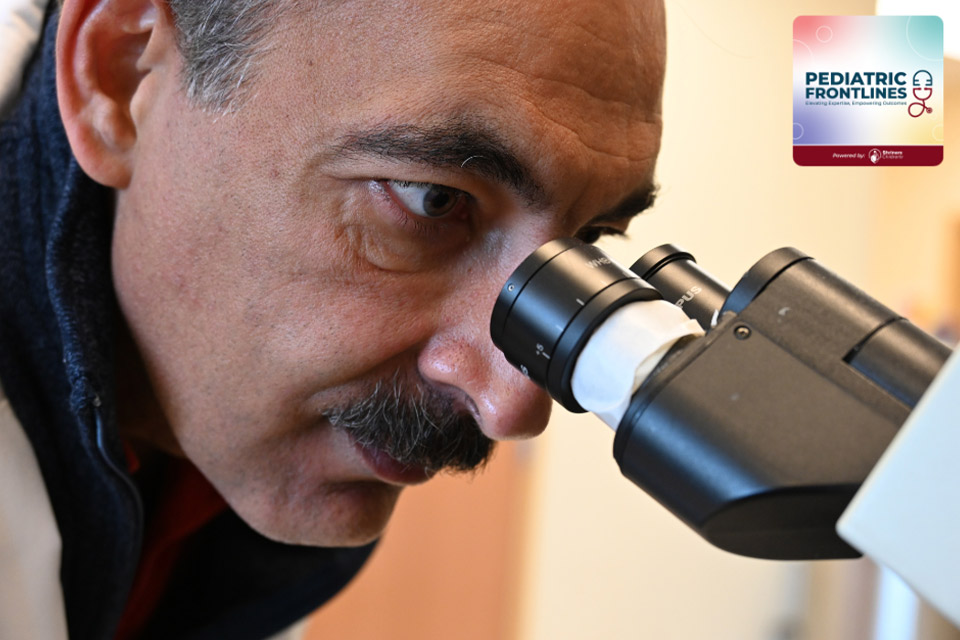 a man looking into a microscope; pediatric frontlines logo