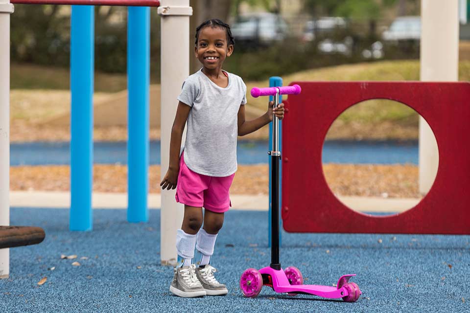 Little girl on adaptive playground