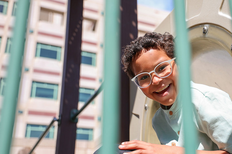 Boy smiling while playing on playground