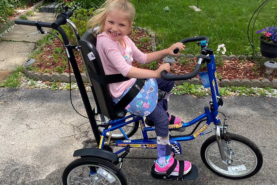 Girl riding an adaptive bike