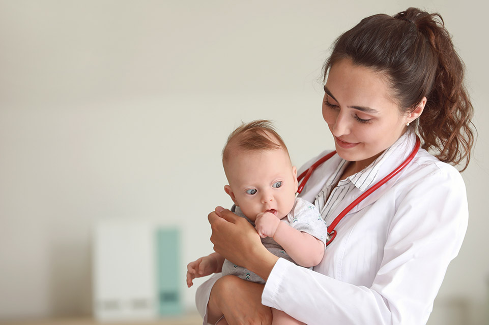 physician examines baby