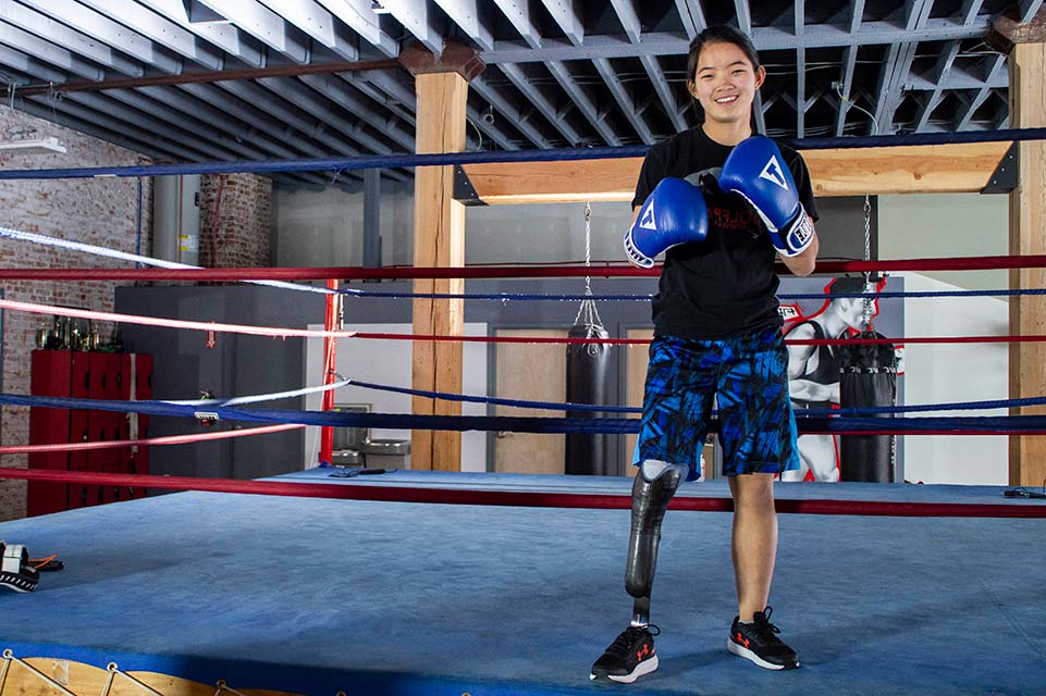 female with prosthetic leg boxing