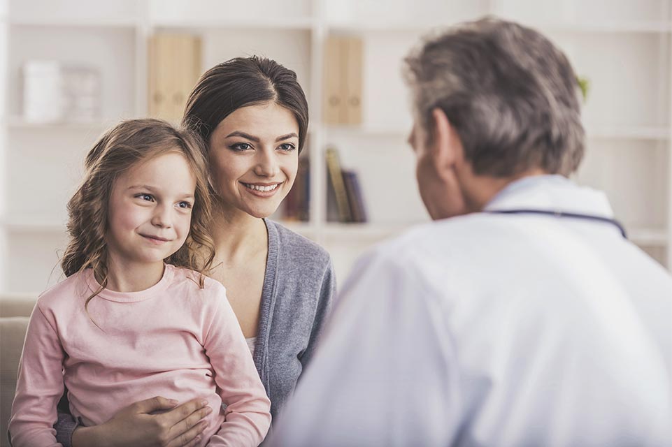mother, daughter speaking to physician