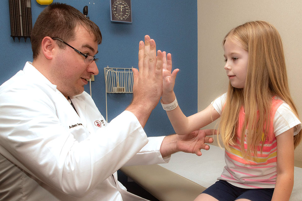 physician and female patient high five