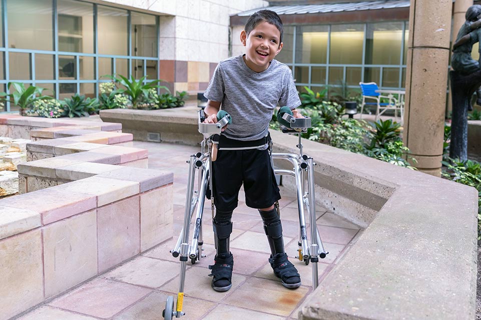 cerebral palsy patient outside using walker