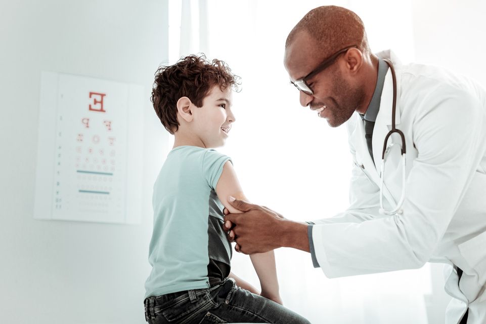 physician examines patient elbow