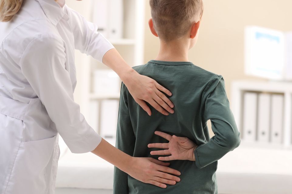 physician examines patient's back