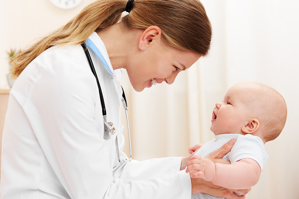 female physician examines infant
