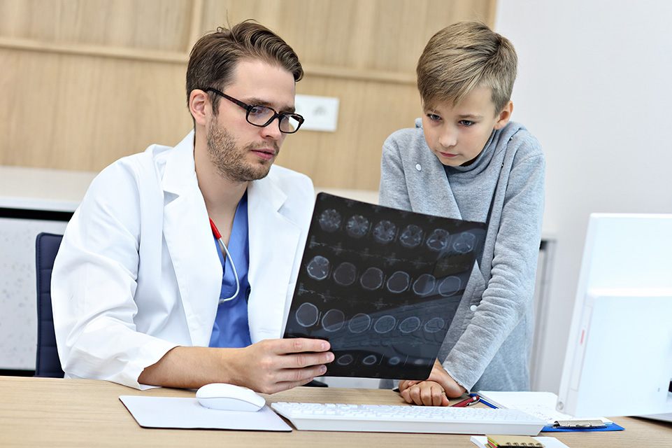physician and patient looking at xrays