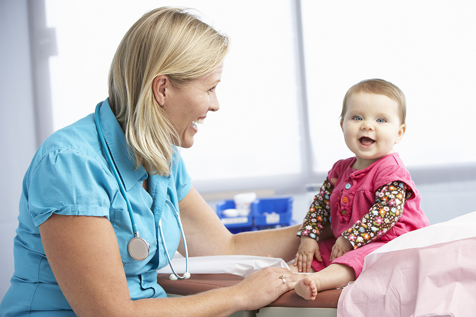 physician examining baby