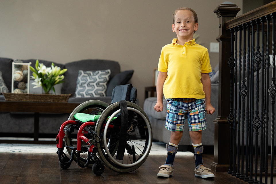 un patient debout à côté d’un fauteuil roulant