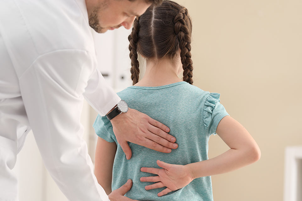 physician examines patient spine