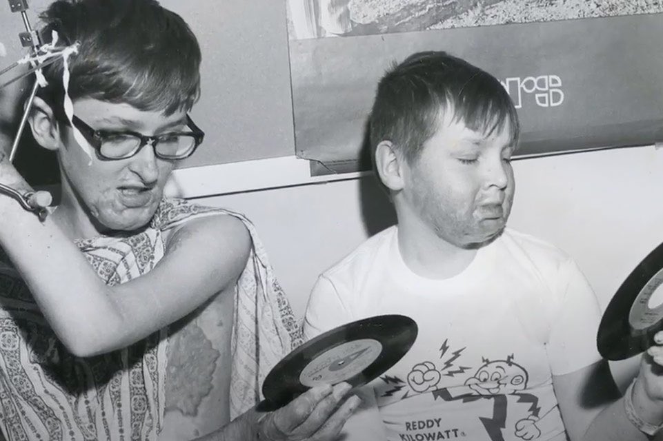 Two boys holding records 